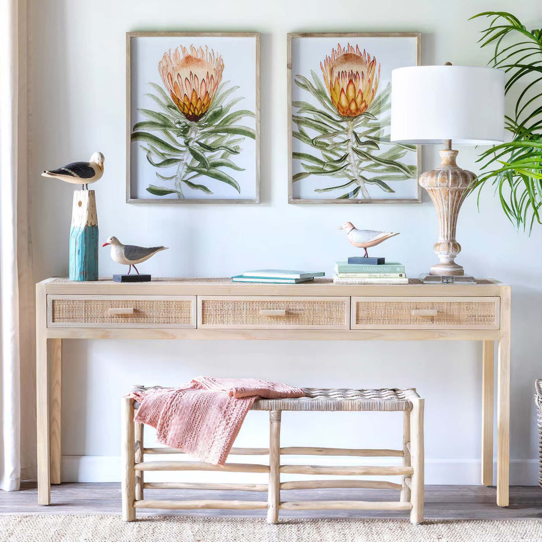 Vintage coastal decor with driftwood table, seashells, bird figurines, and coastal art enhancing seaside serenity in your home.