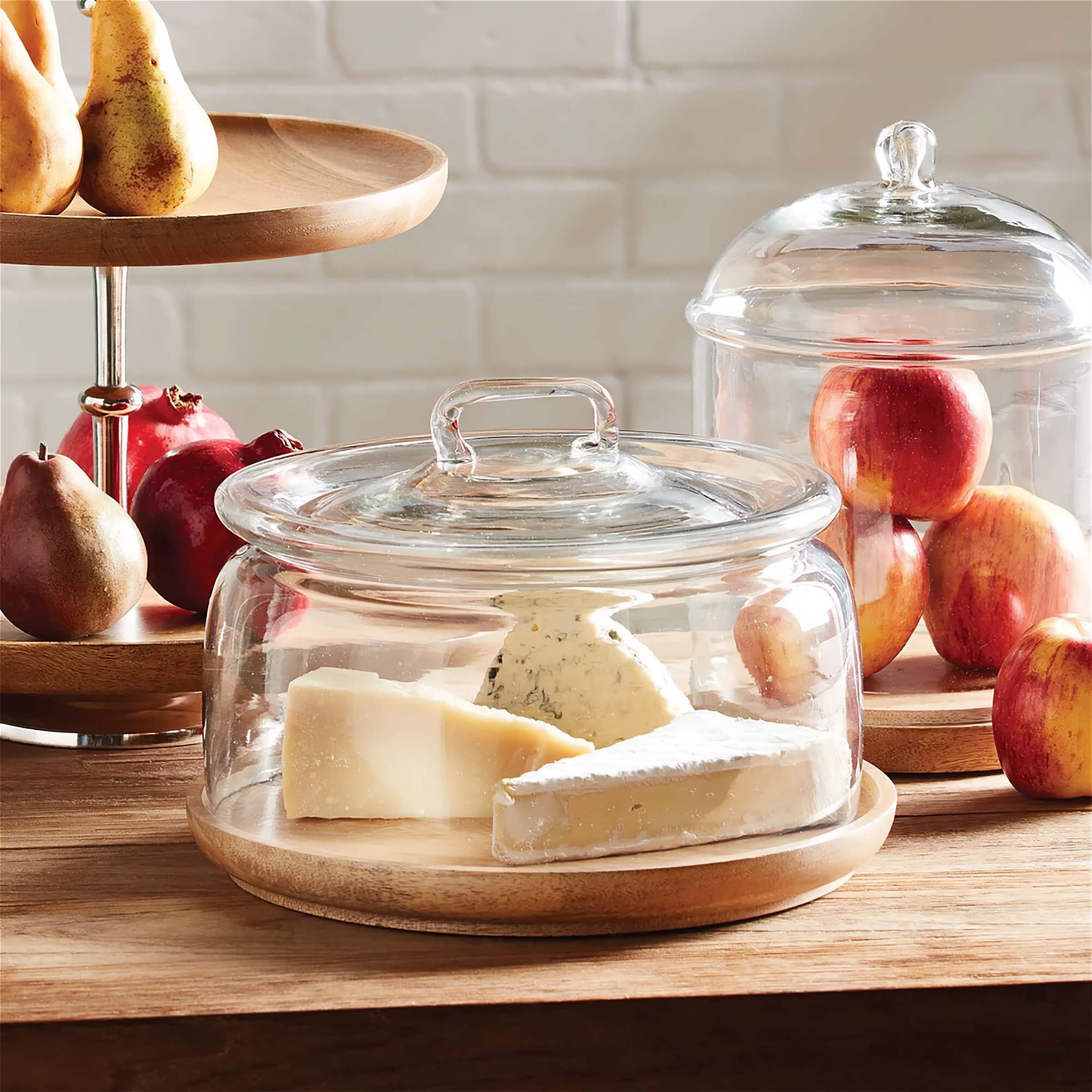 Vintage cloche display with cheese and fruit, showcasing timeless elegance and antique style glass domes for preservation.