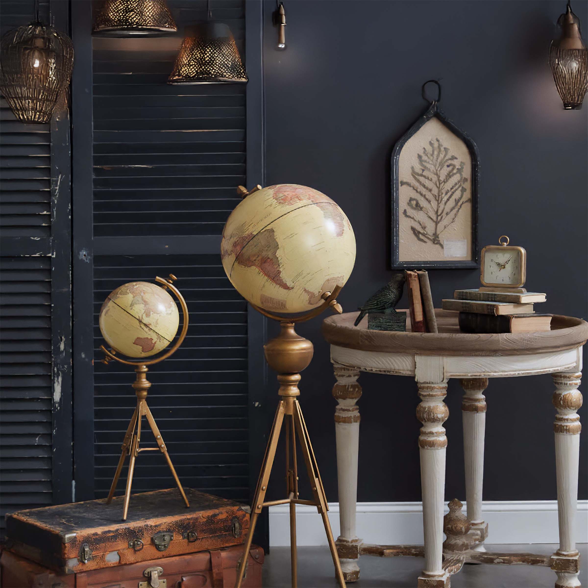 Vintage-inspired home decor with globes, antique table, and suitcase, creating a timeless ambiance perfect for unique gift ideas.