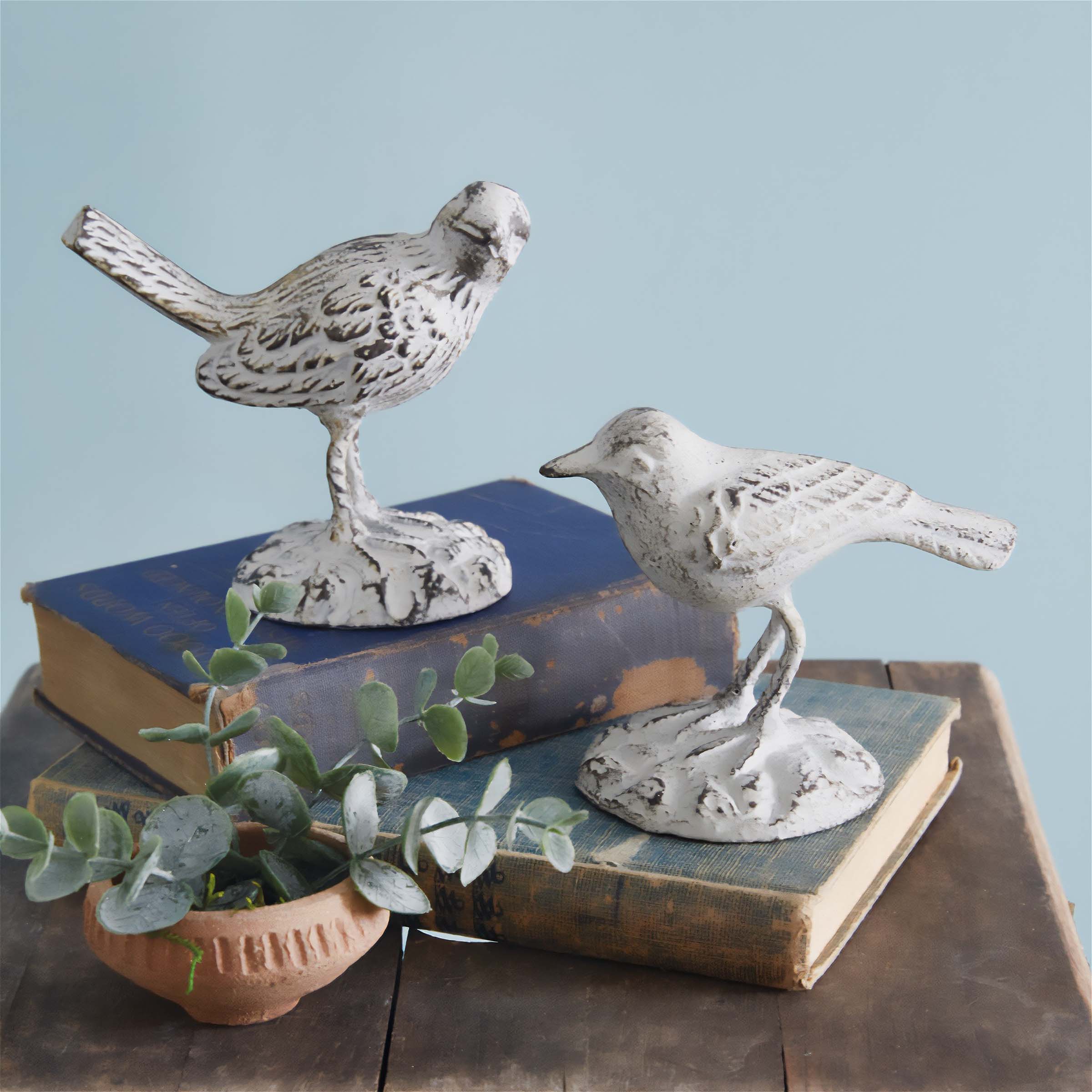 Vintage bird figurines on books, part of the Vintage Statues & Figurines Collection, embody artistry and elegance.
