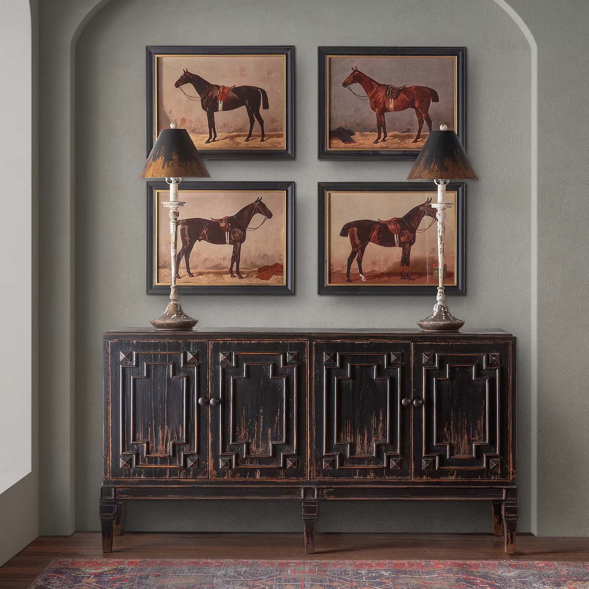 Vintage-style table lamps on a rustic cabinet with horse paintings, showcasing antique-inspired home décor elegance.