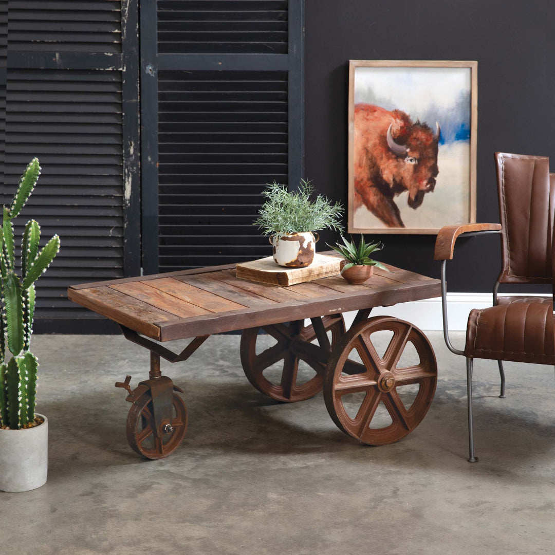 Vintage Western décor with rustic coffee table, leather chair, and bison art, capturing the spirit of the American frontier.