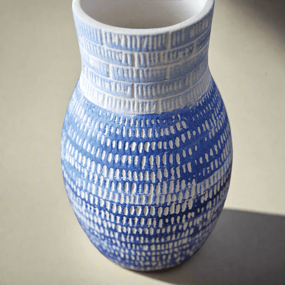 Handcrafted blue and white textured ceramic vase, ideal for modern home decor and elegant accents.