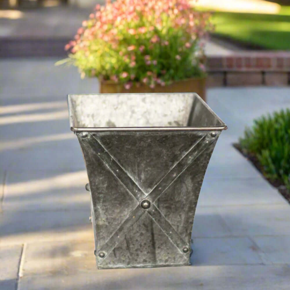 Antique galvanized metal square planter with hand-riveted detailing, perfect for farmhouse decor.