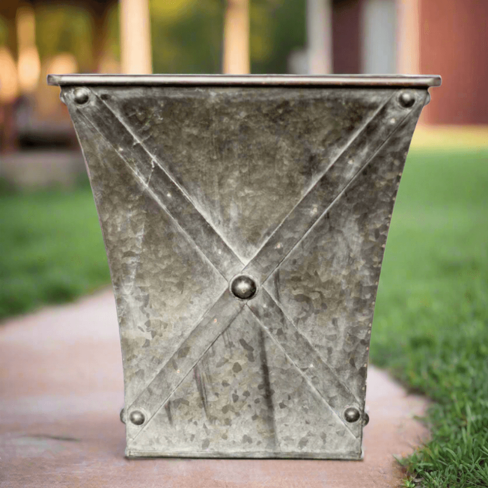 Antique galvanized metal square planter with weathered finish and hand-riveted details, perfect for farmhouse decor.