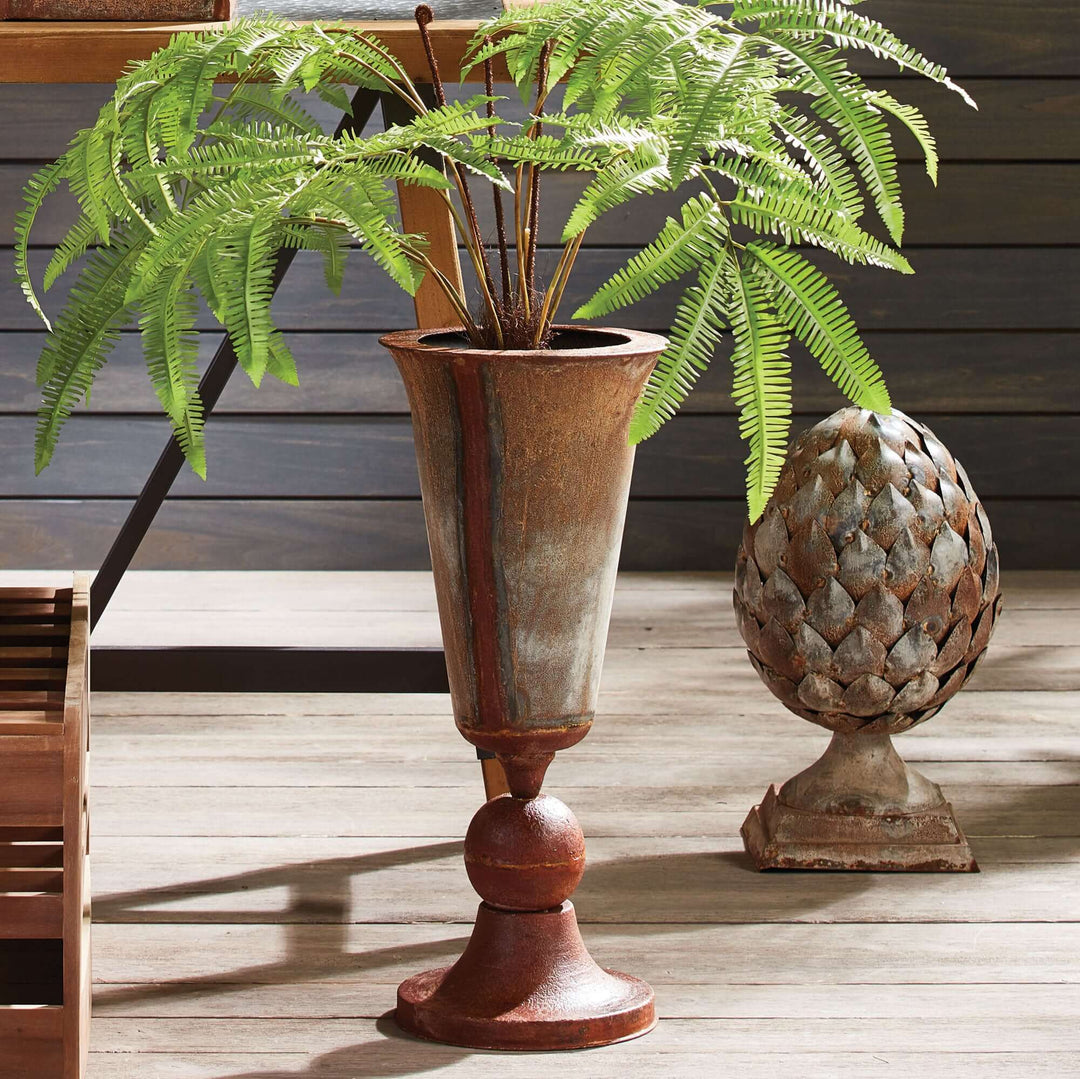 Antique Style Weathered Metal Urn Planter with a fern in it