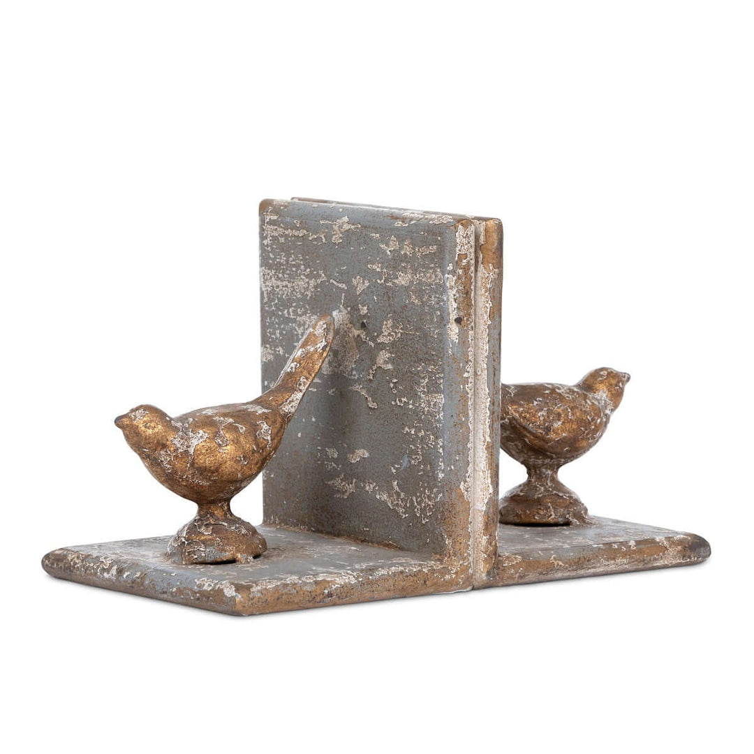 Vintage metal bird bookends with gilded accents, crafted from solid iron, offering sturdy and charming support for books.