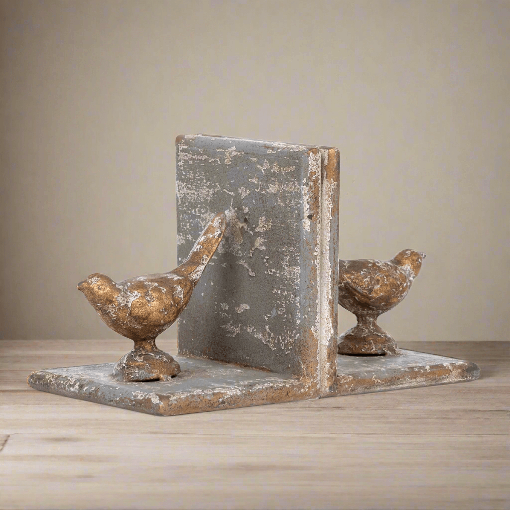 Vintage metal bird bookends with a rustic finish, crafted from solid iron with gilded accents, evoke a nostalgic, literary charm.