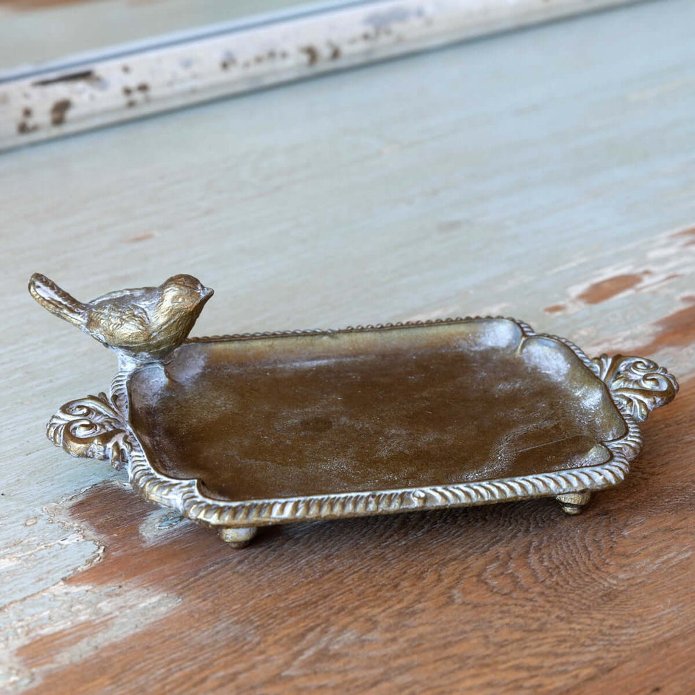Antique brass bird soap dish with vintage-inspired patina, evoking charm and nostalgia of cozy cottage bathrooms and farmhouse kitchens.