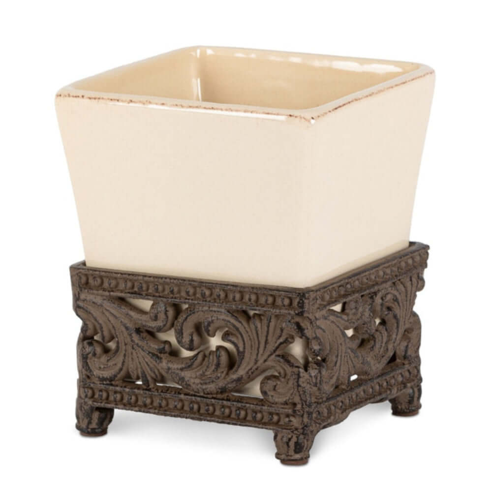 Victorian ceramic vase with cream glaze and ornate acanthus leaf metal base, antique bronze finish, elegant square shape.