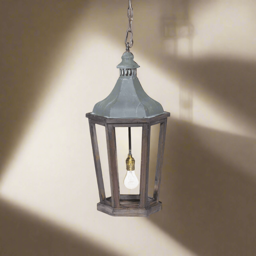 Decorative hanging lantern with a light bulb inside on a neutral background