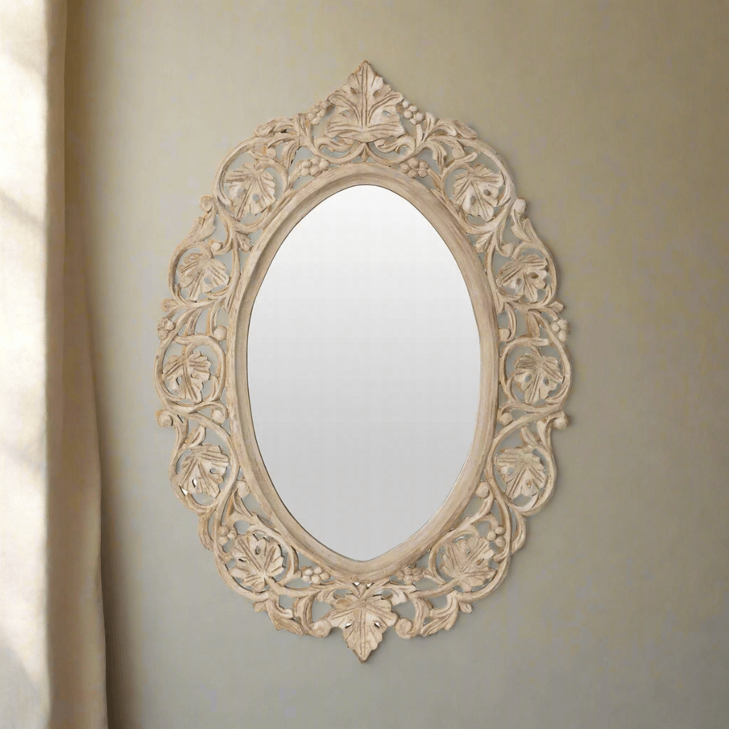Vintage hand-carved wood wall mirror with intricate floral scrollwork and elegant oval shape, perfect for antique-style interiors.