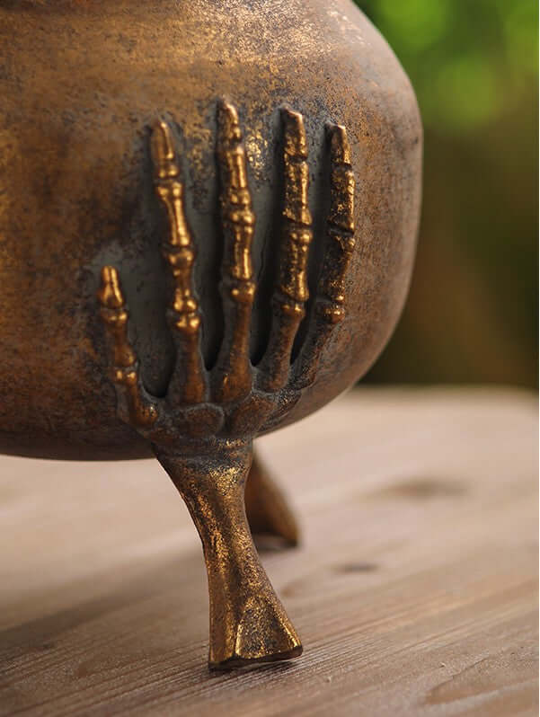 Gothic Skeleton Hands Iron Vase with antique gold finish and detailed skeleton hand base, Victorian-style decor piece