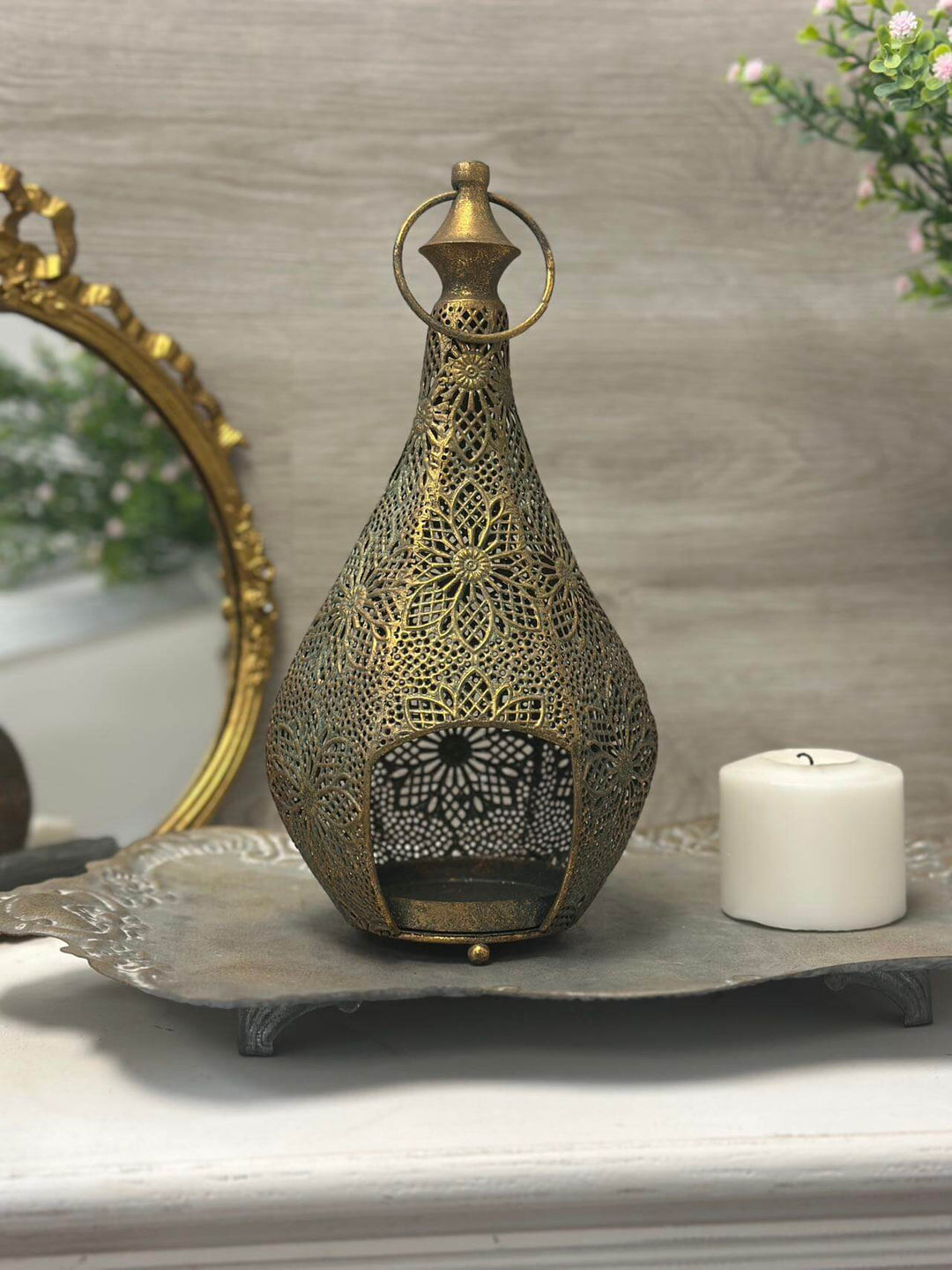 Vintage brass teardrop lantern with floral filigree, featuring intricate design and warm candlelight ambiance.