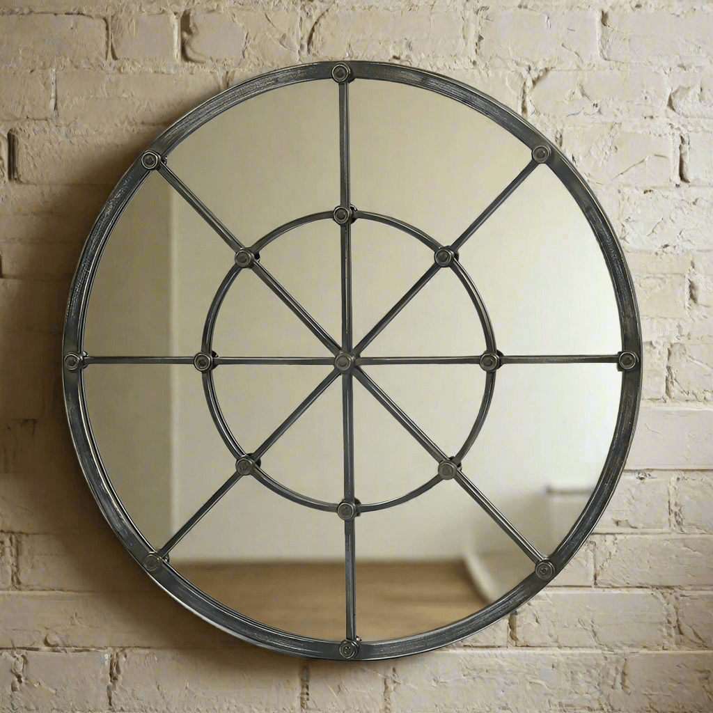 Large round industrial grid wall mirror with metal framing and windowpane design, enhancing vintage rustic charm.