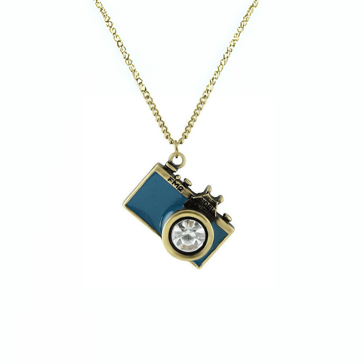 Vintage Camera Pendant Necklace with teal enamel body and crystal lens charm on brass chain.
