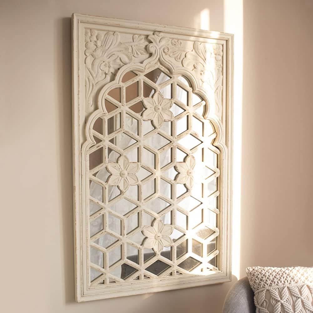 Vintage floral lattice wall mirror with intricate design and distressed white finish, perfect for adding charm to any space.