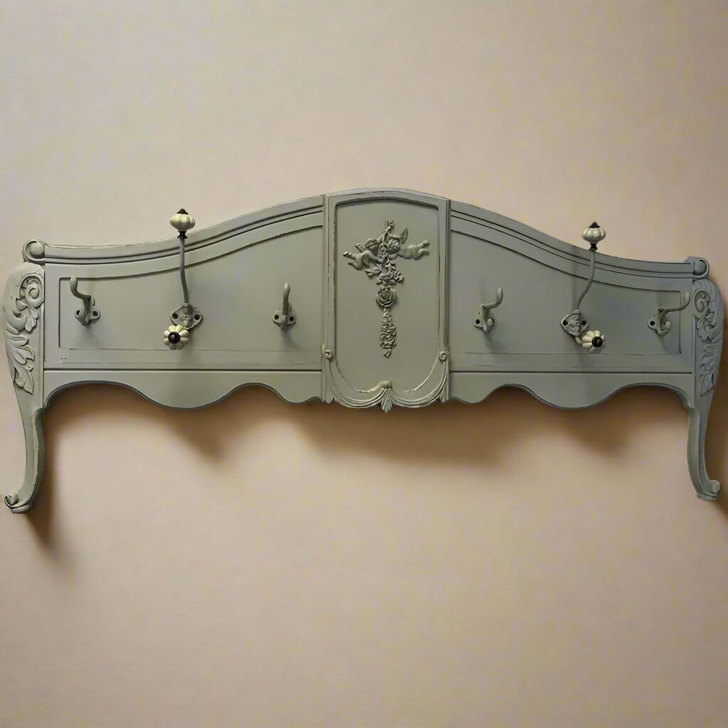 Vintage French country wall-mounted coat rack with ornate carvings and a charming distressed green finish.