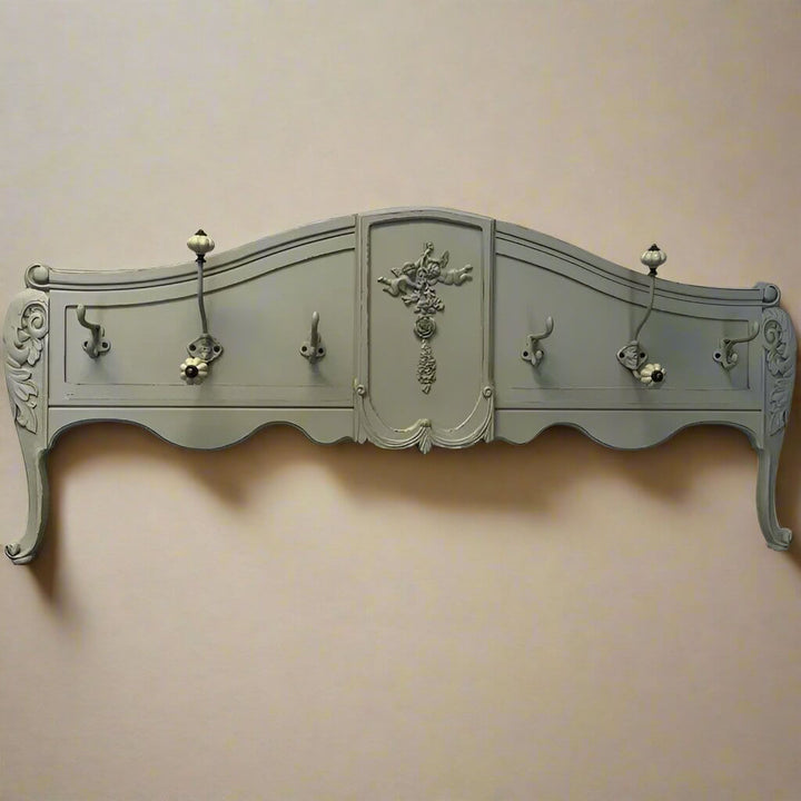 Vintage French country wall-mounted coat rack with ornate carvings and a charming distressed green finish.