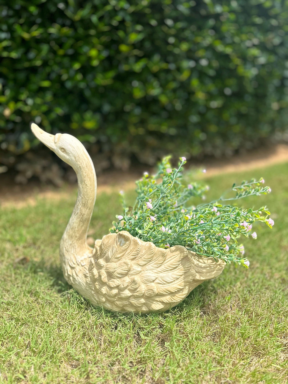 Vintage Goose Planter with greenery, adding elegance to outdoor decor and showcasing intricate feather detailing.