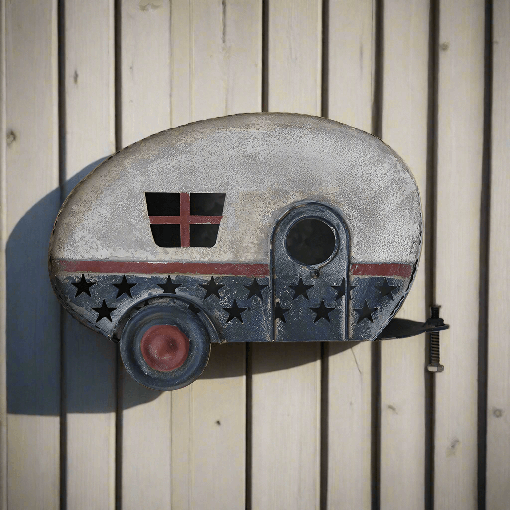 Vintage patriotic camper birdhouse resembling a retro travel trailer with weathered finish and Americana details.
