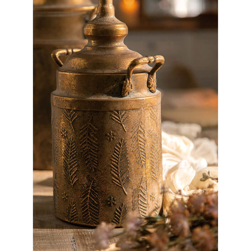 Antique brass embossed storage canister with lid, featuring intricate detailing and vintage design in warm, nostalgic farmhouse style.