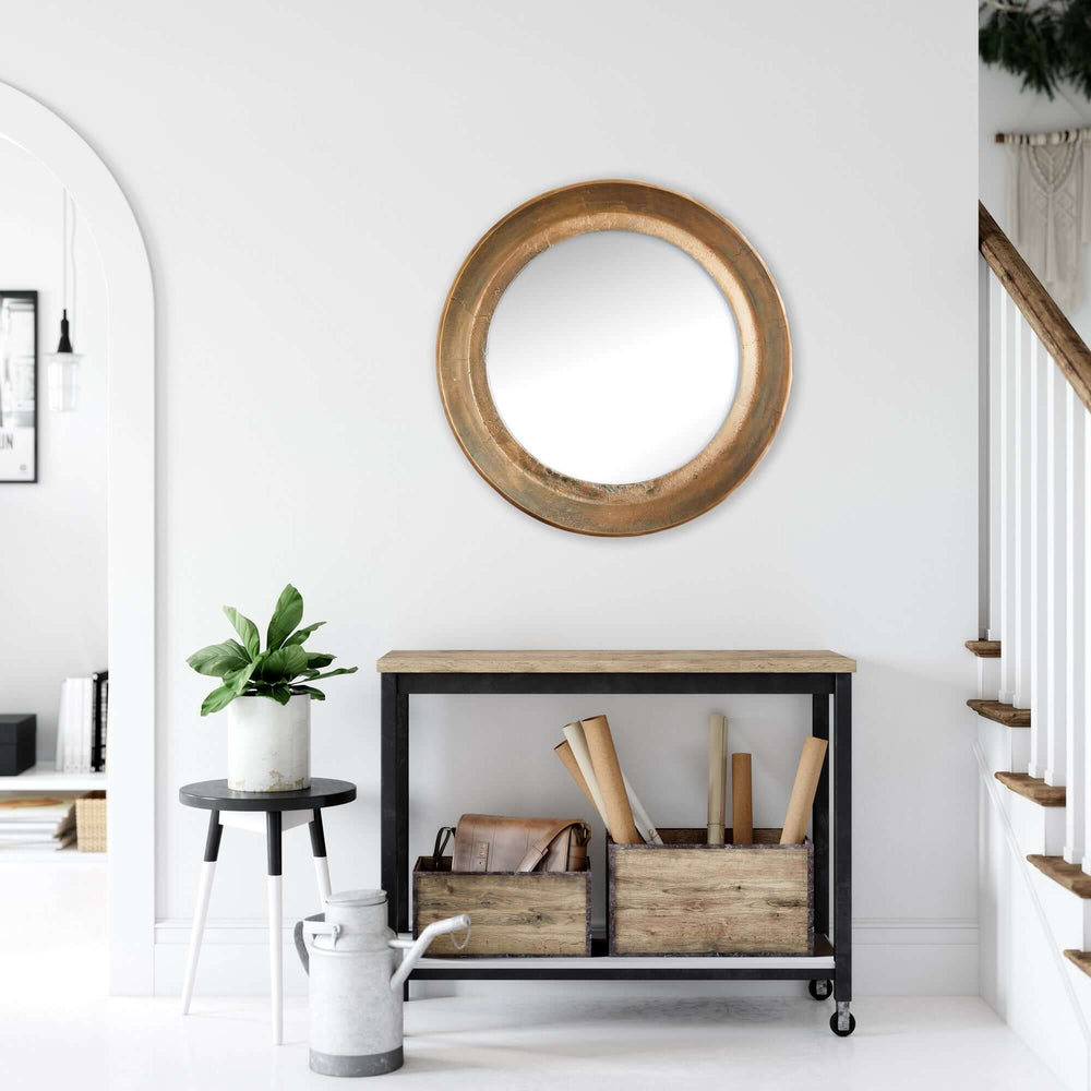 Antique nickel round wall mirror with distressed finish in a modern entryway setting.