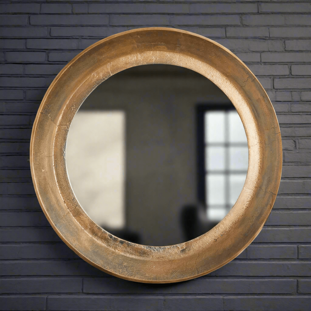 Antique nickel round wall mirror with distressed finish reflecting vintage elegance and charm.