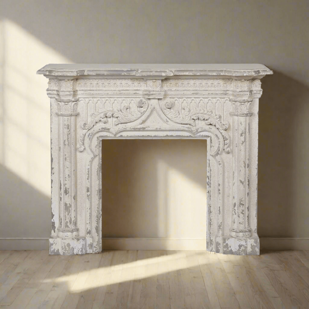 Antique white fireplace mantel with distressed vintage finish against a sunlit wall, showcasing detailed craftsmanship and timeless charm.