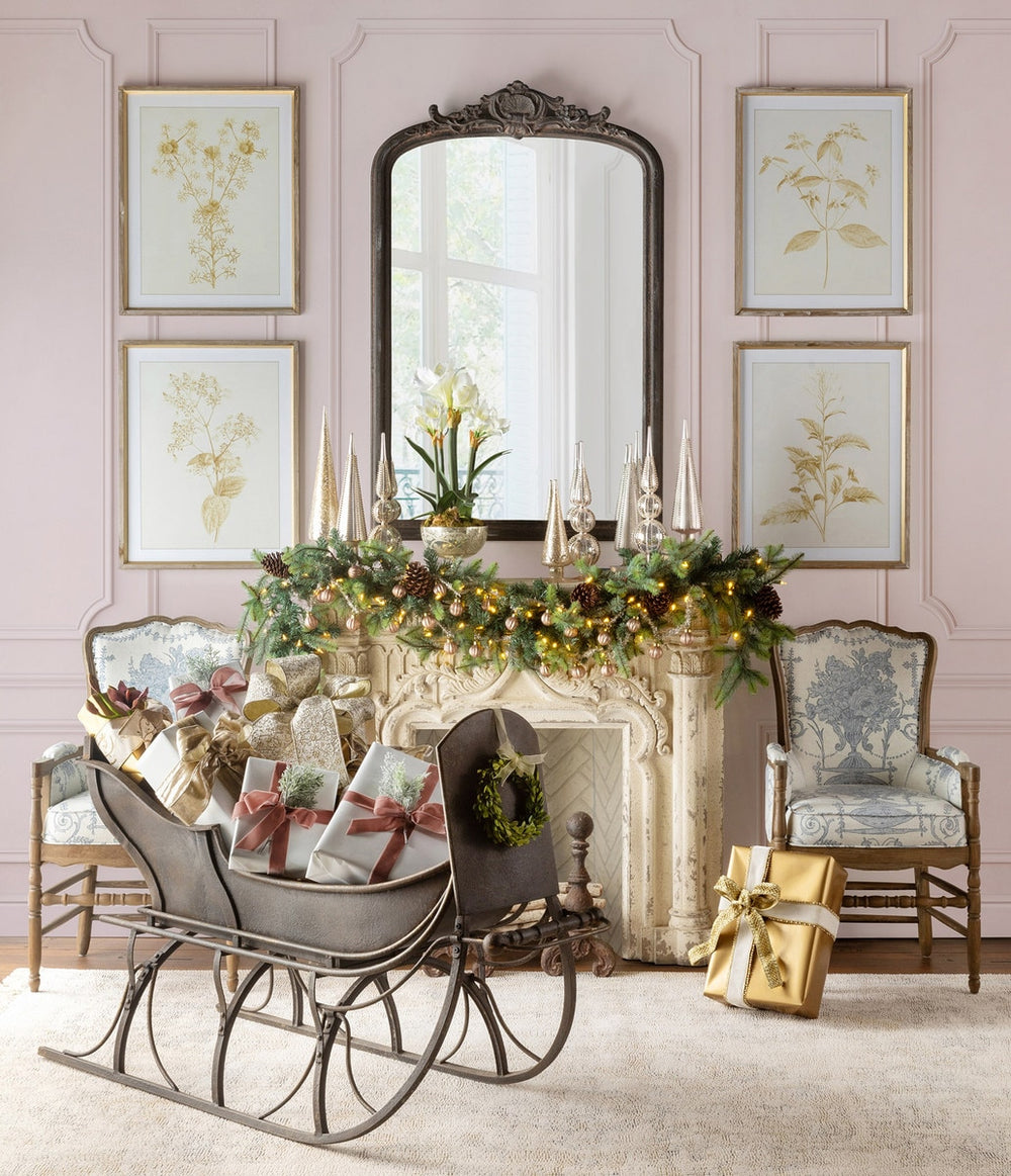 Antique Iron Cutter Sleigh Christmas Décor in elegant living room with festive garlands and wrapped gifts, capturing holiday nostalgia.