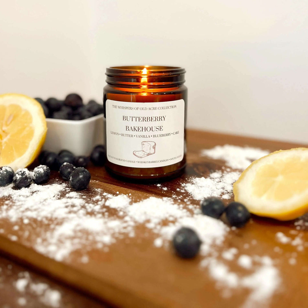 Butterberry Bakehouse Scented Candle: Blueberry & Lemon with lemon slices, blueberries, and flour on a wooden table.