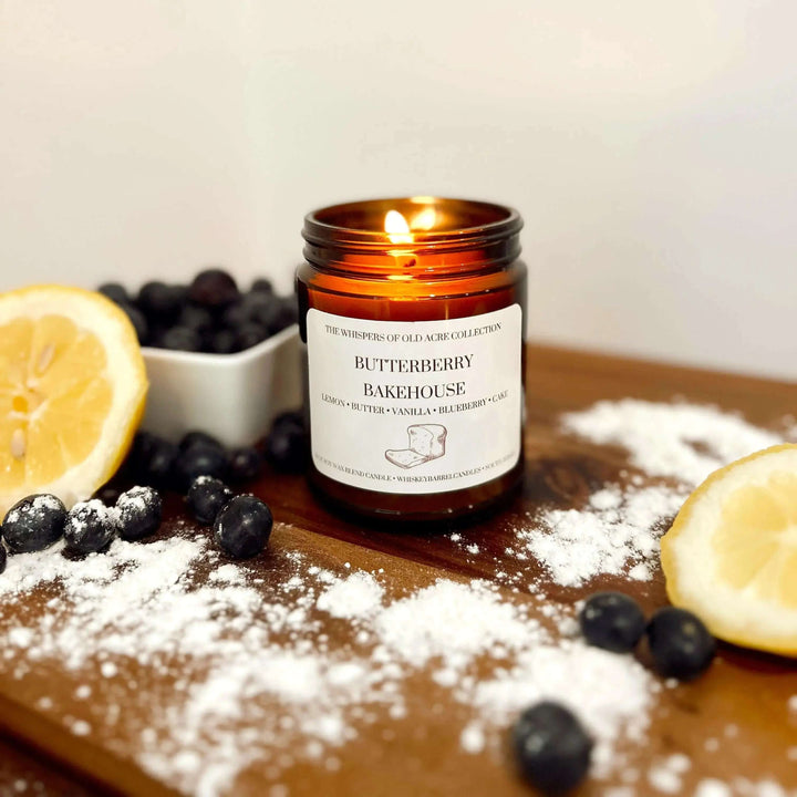 Butterberry Bakehouse Scented Candle: Blueberry & Lemon on wooden table with blueberries and lemon slices.
