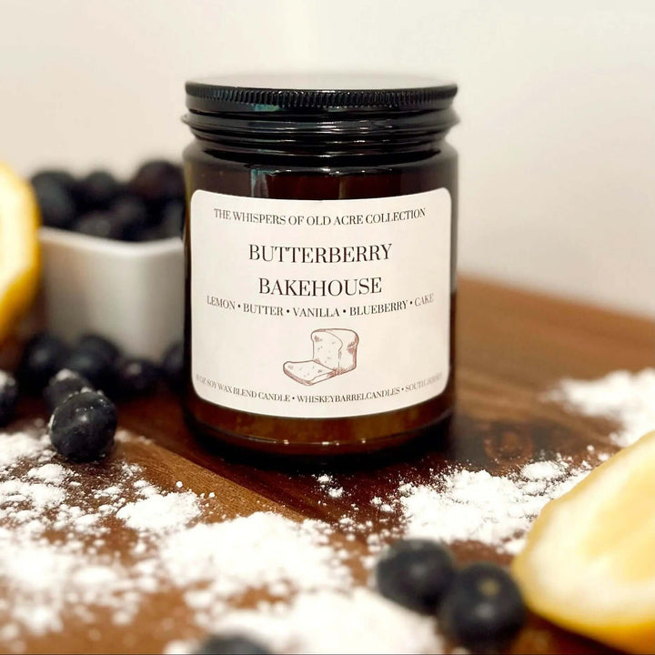 Butterberry Bakehouse Scented Candle: Blueberry & Lemon surrounded by fresh blueberries and lemon on a flour-dusted wooden table.