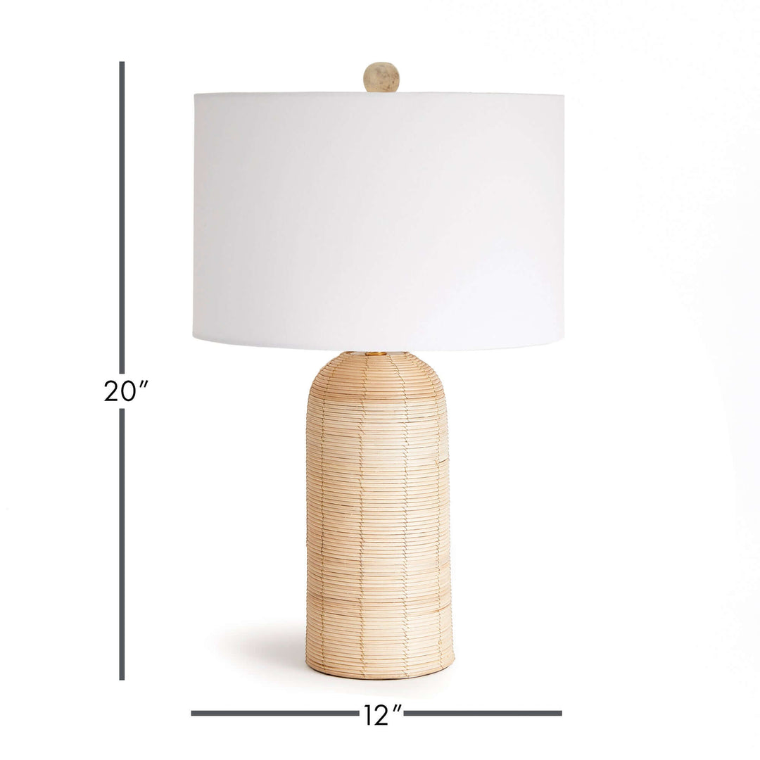 Coastal woven rattan table lamp with white drum shade, measuring 20" tall and 12" wide, ideal for beach-inspired decor.