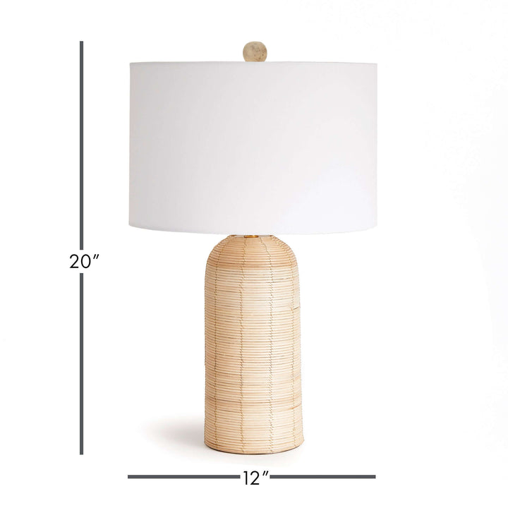Coastal woven rattan table lamp with white drum shade, measuring 20" tall and 12" wide, ideal for beach-inspired decor.
