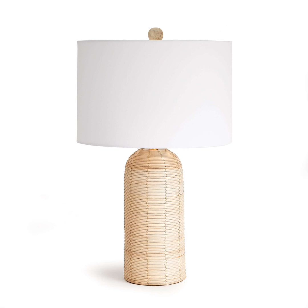 Coastal woven rattan table lamp with a white drum shade, perfect for airy and serene home decor.