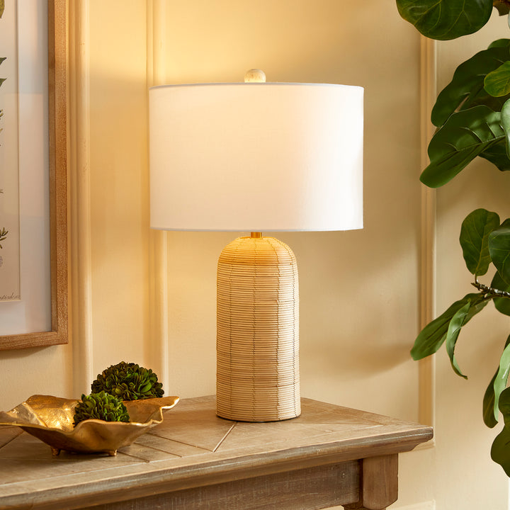 Coastal woven rattan table lamp with white drum shade, perfect for adding a seaside touch to home decor.