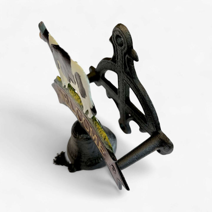 Side view of Farmhouse Cast Iron Cow Welcome Sign with Bell showcasing rustic design for home decor.