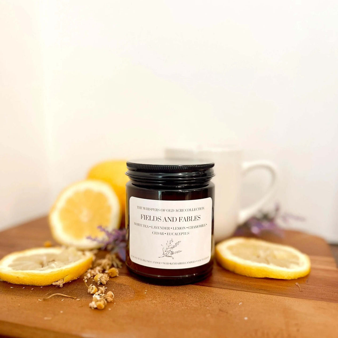 Fields and Fables Scented Candle: Chamomile, Lavender & Driftwood with lemons and chamomile flowers.