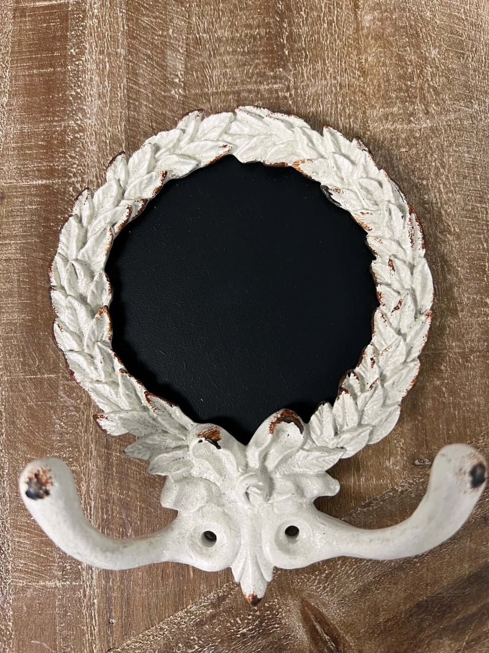 French country wall hook with round chalkboard center, featuring elegant leaf design and durable pewter construction.