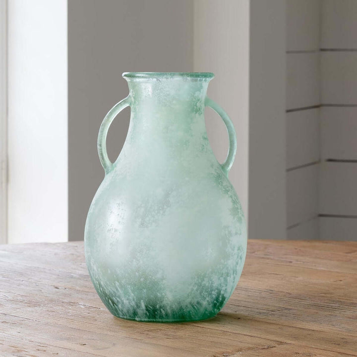 Frosted Seafoam Glass Vase with Handles on wooden surface, featuring a translucent seafoam hue and amphora-inspired shape.