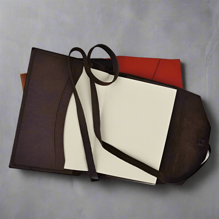 Handcrafted Italian Leather Wrap Journal with tie closure, open to reveal blank pages, showcased on a stylish background.