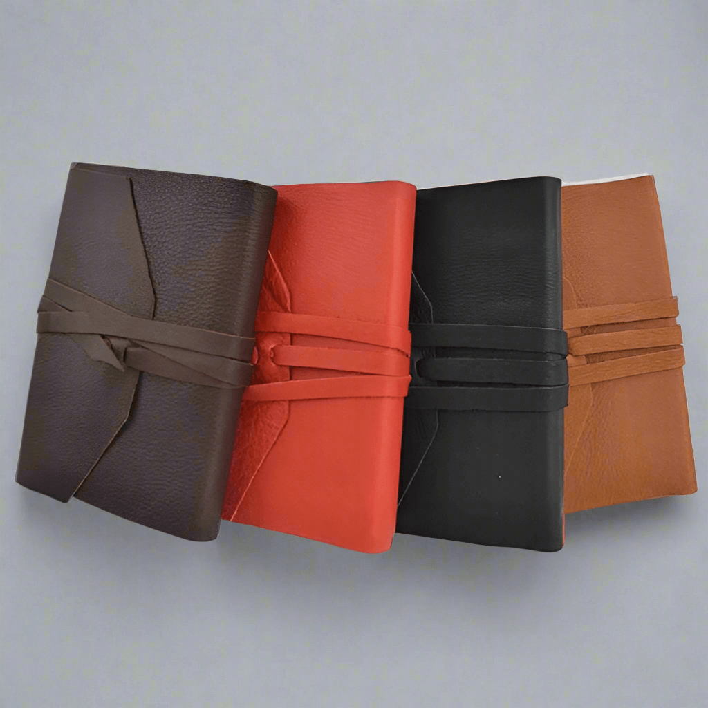 Handcrafted Italian Leather Wrap Journal in four colors: brown, red, black, and tan, showcasing artisanal craftsmanship.