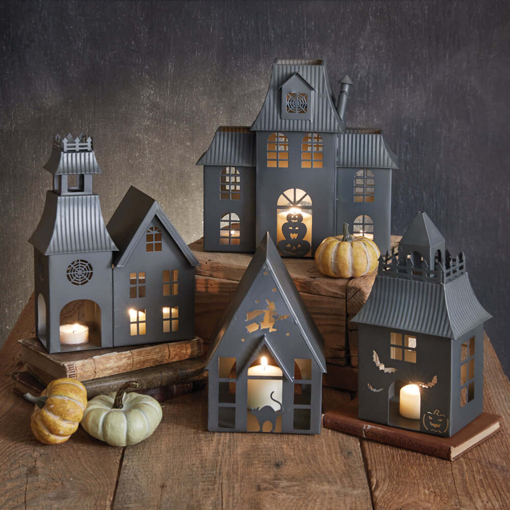 Haunted House Halloween metal tealight luminaries with glowing candles and decorative designs, perfect for vintage Halloween décor.