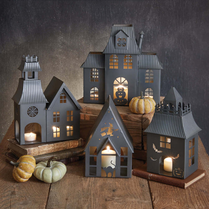 Haunted House Halloween metal tealight luminaries with glowing candles and decorative designs, perfect for vintage Halloween décor.