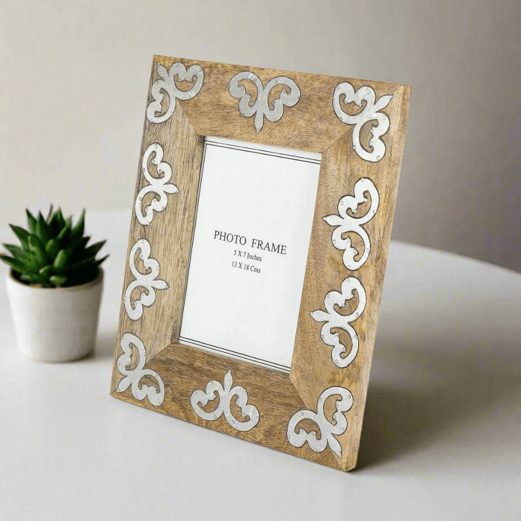 Mango Wood Photo Frame with Metal Inlay (5x7 Display) on a table with a small plant