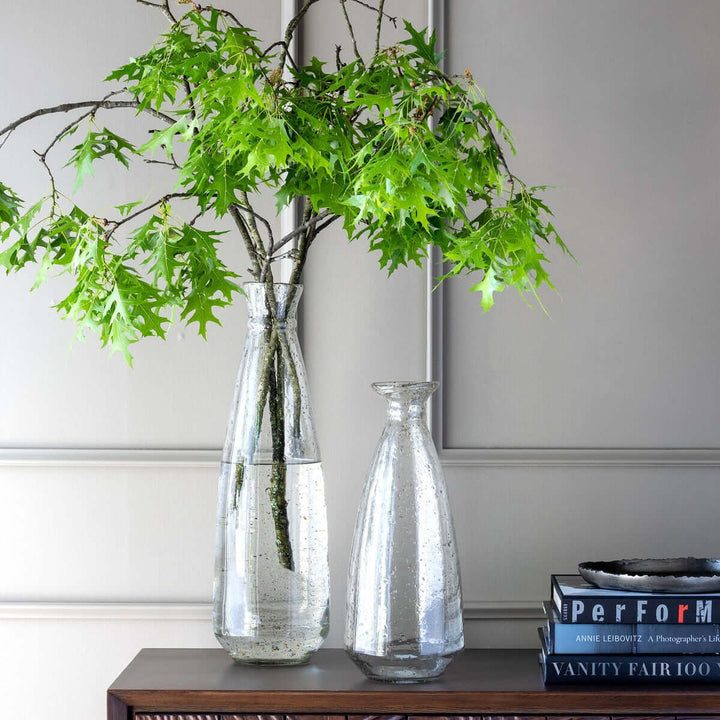 Recycled Glass Coastal Vase with green branches on a wooden table next to books
