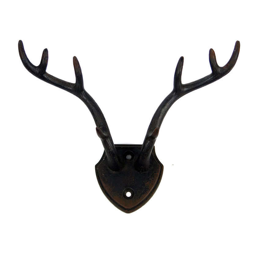 Rustic antler wall hook with shield backplate, ideal for lodge decor and rustic charm accents.