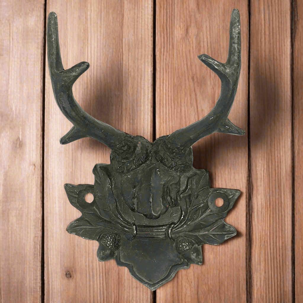 Rustic antler wall hook with vintage lodge design on wooden background, perfect for cabin decor.