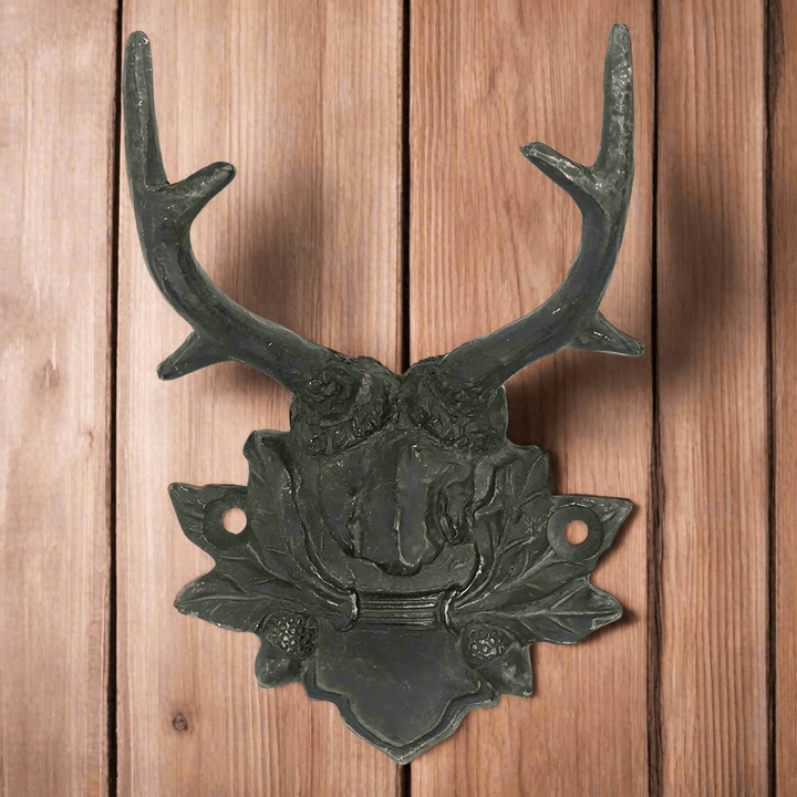 Rustic antler wall hook with vintage lodge design on wooden background, perfect for cabin decor.